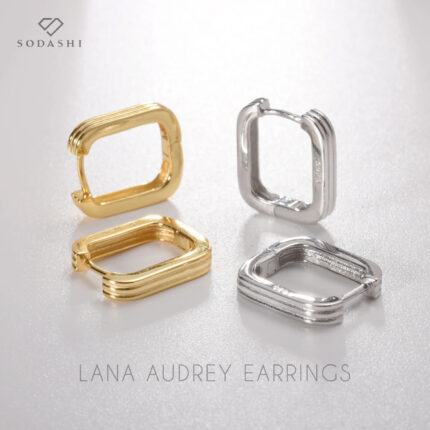 Discover the perfect blend of retro charm and modern elegance with the Lana Audrey Hoops by Sodashi. These stunning rectangle hoops feature a unique band design, offering a sophisticated twist on a classic look. Available in both silver and gold plated options, each piece is crafted from high-quality sterling silver, ensuring durability and a luxurious finish. Elevate your style effortlessly with these versatile earrings, perfect for any occasion.