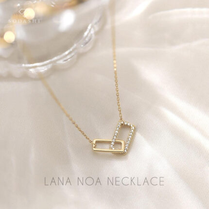Introducing the Lana Noa Necklace by Sodashi, a timeless piece that captures elegance and sophistication. Featuring a unique design with a rectangle plain sterling silver pendant linked to a cubic zirconia studded rectangle pendant, this necklace is perfect for adding a touch of glamour to any outfit. Available in both silver and gold plated finishes, it offers versatility to match any style. Crafted from high-quality sterling silver, the 45CM chain ensures a comfortable fit. The Lana Noa Necklace is a stunning accessory that enhances your look with its refined beauty and exquisite detail. Discover this exquisite piece at Sodashi today.