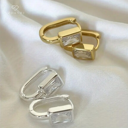 Introducing our latest obsession: Lana Sia Earrings by Sodashi!  Elevate your elegance with these stunning square cubic zirconia pendant stones, available in classic silver or luxurious gold. Crafted from high-quality sterling silver, these earrings are the perfect blend of sophistication and sparkle. Whether you're dressing up for a special occasion or adding a touch of glamour to your everyday look, Lana Sia earrings are your go-to accessory. 